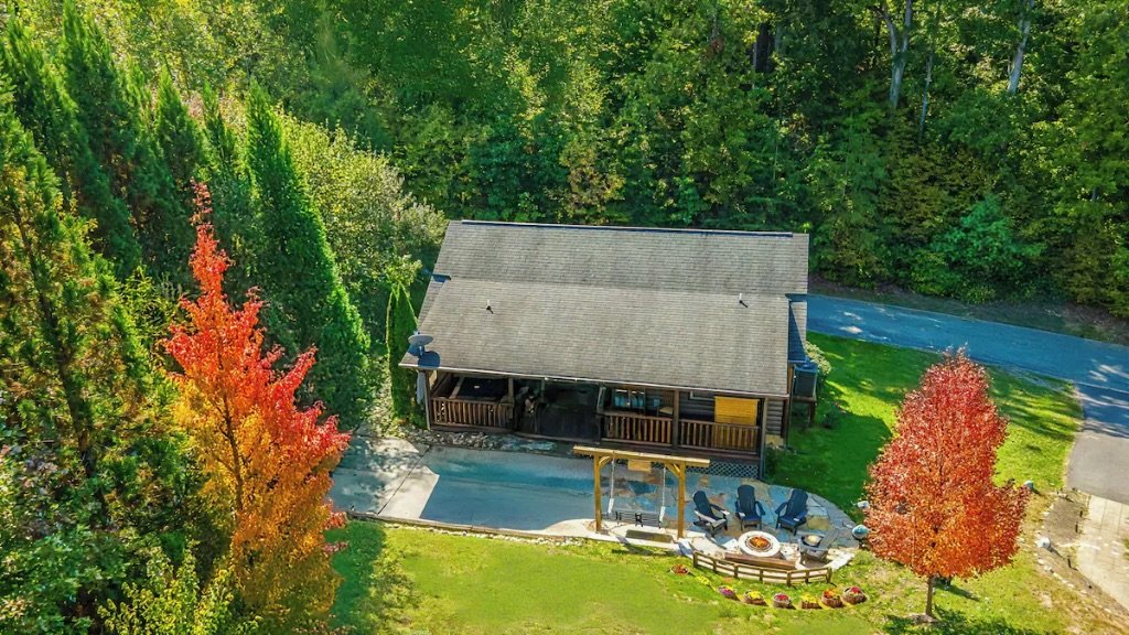 Pigeon Hills aerial view of cabin with fire pit fall foliage and mountain forest surroundings