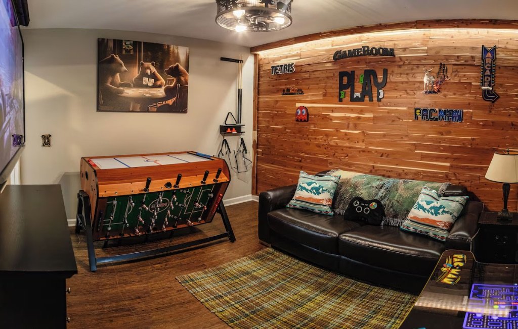 Pigeon Hills game room with air hockey foosball leather couch and PLAY wall art