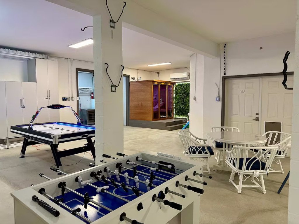Seaside Boca game room with air hockey foosball sauna and lounge seating