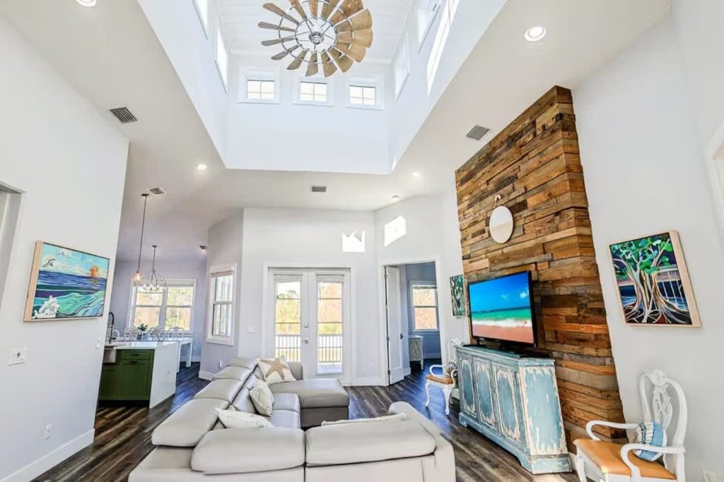 Seaside Boca living room with vaulted ceilings and reclaimed wood accent wall