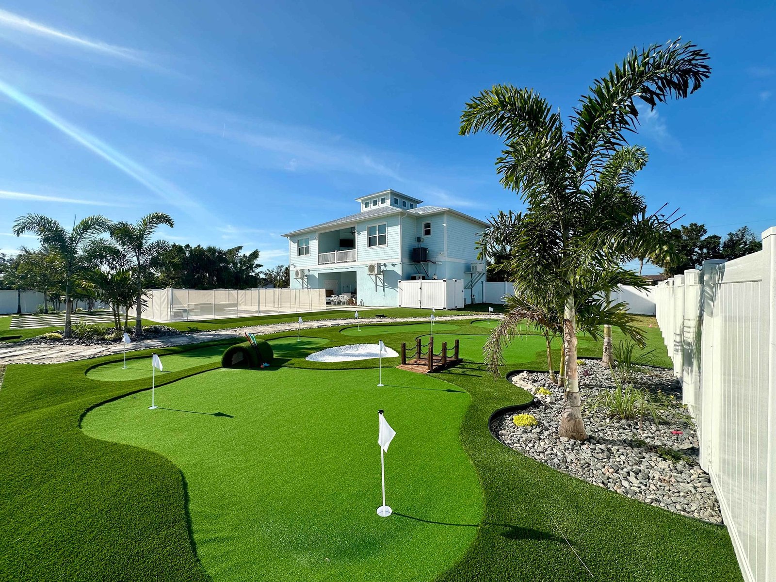 Seaside Boca resort-style pool with tropical landscaping and outdoor living spaces